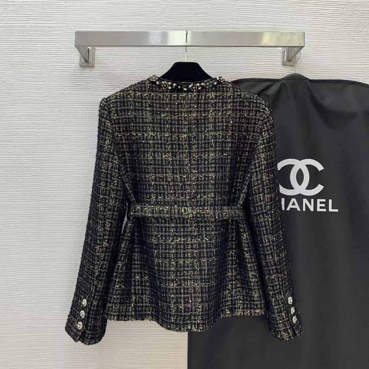 Black and gold heavy-duty tweed jacket with embellished beading and diamante details.