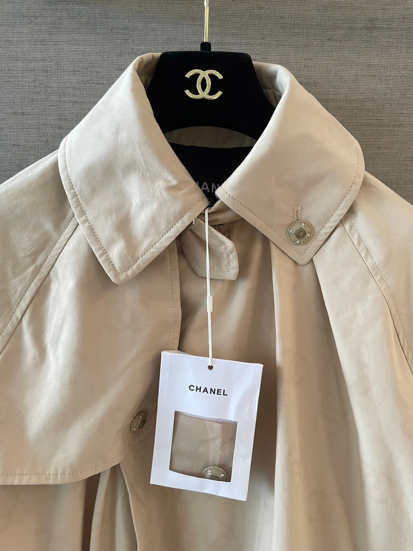 Logo becomes clearer when wet. Trench coat.