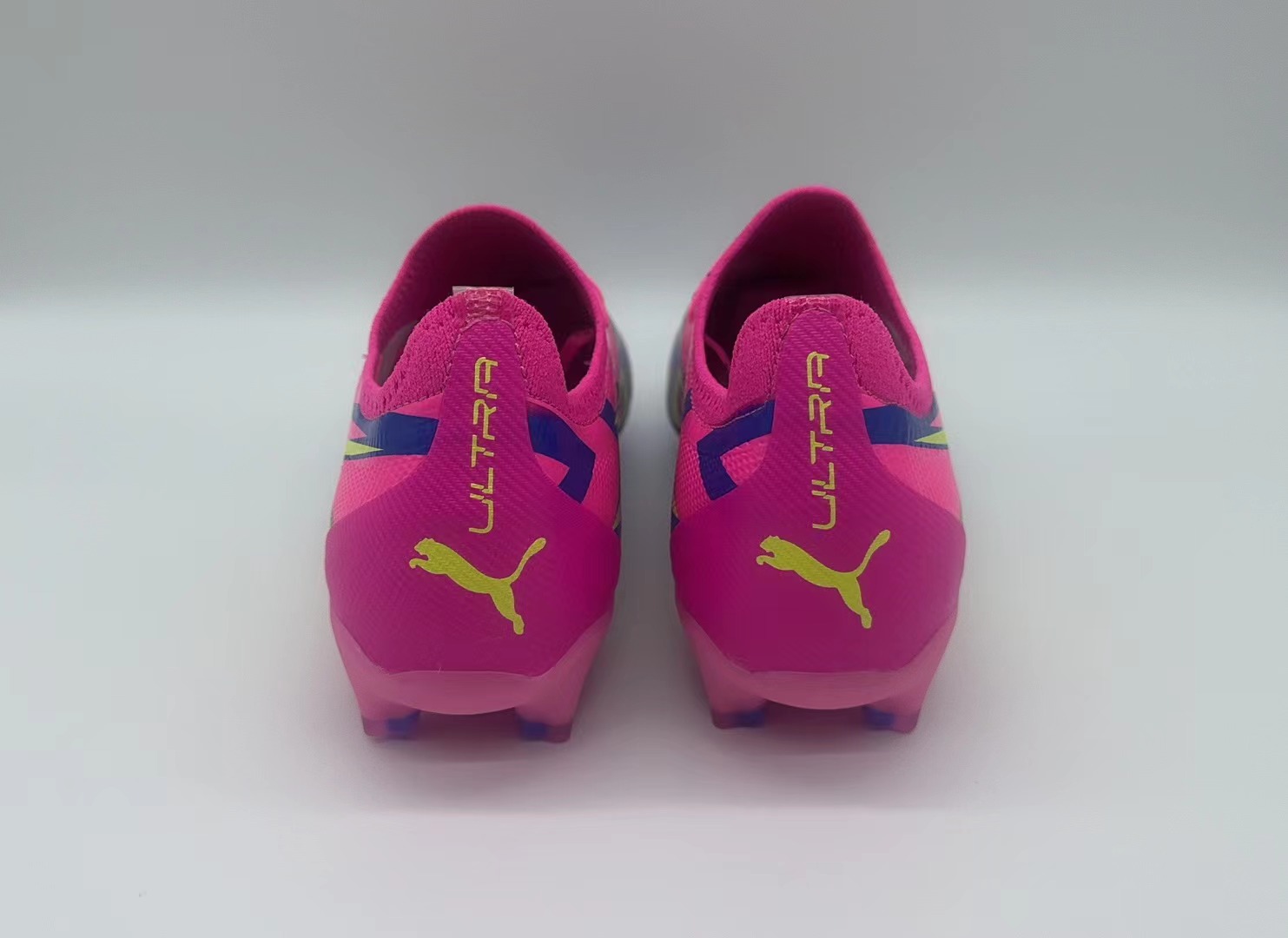 Rose red, blue and yellow football shoes