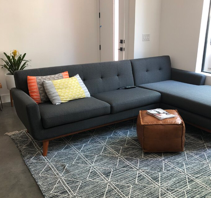 Giuliana 104″ Wide Faux Leather Reversible Sofa & Chaise with Ottoman