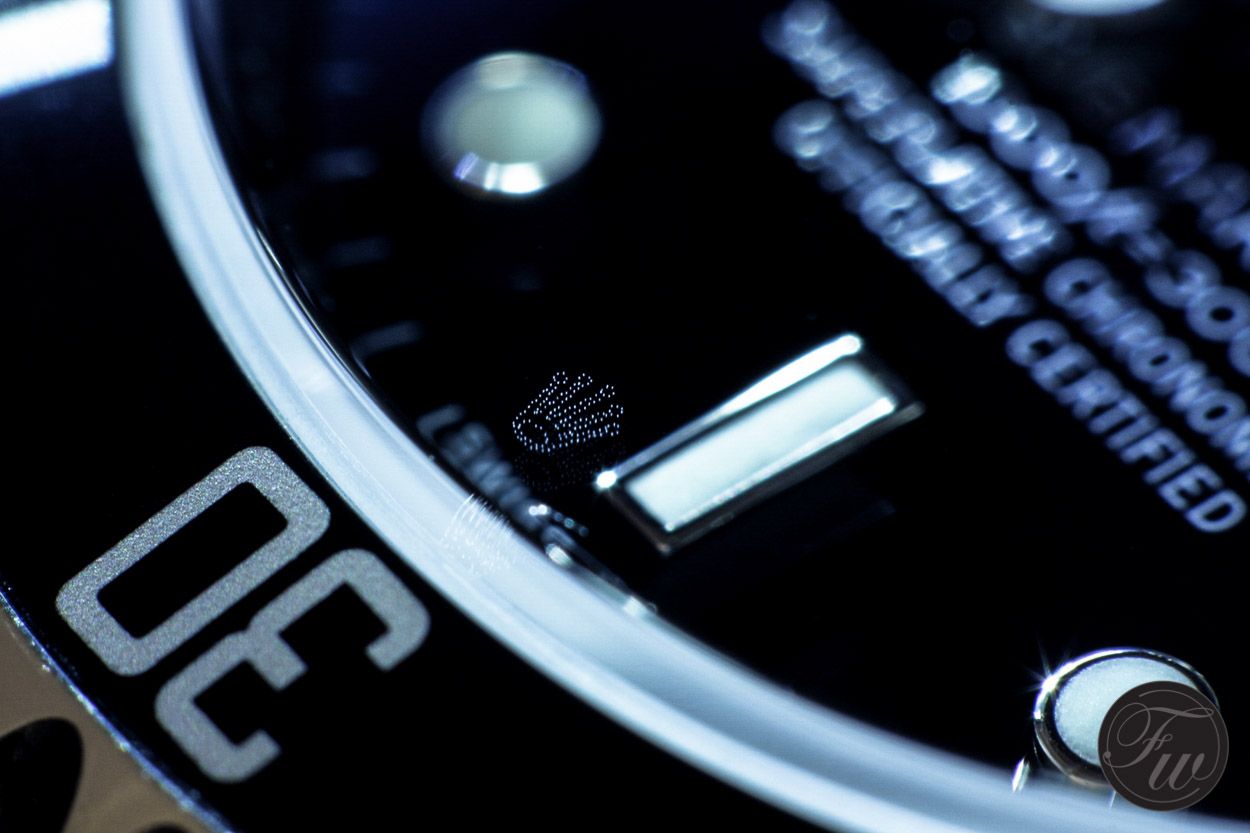 Laser-etched Rolex crown under magnification